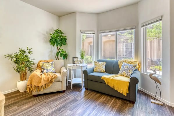A cozy seating area with plants and natural light