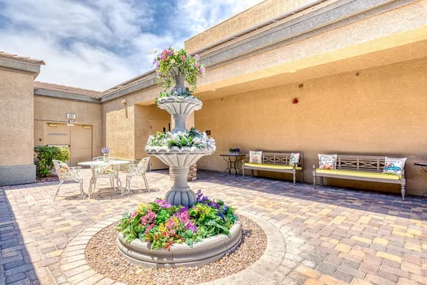 Outdoor courtyard with a fountain and seating