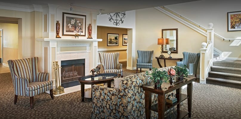 Bright common area with comfortable seating and a fireplace