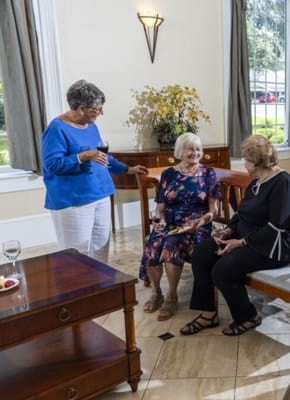 Three residents chatting in a common area