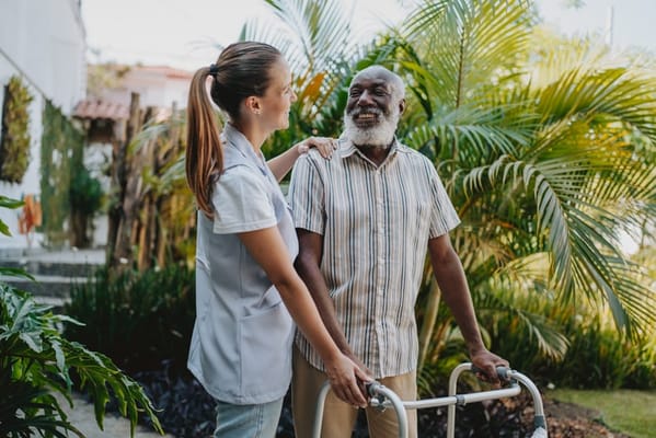 Care staff assisting a resident outdoors