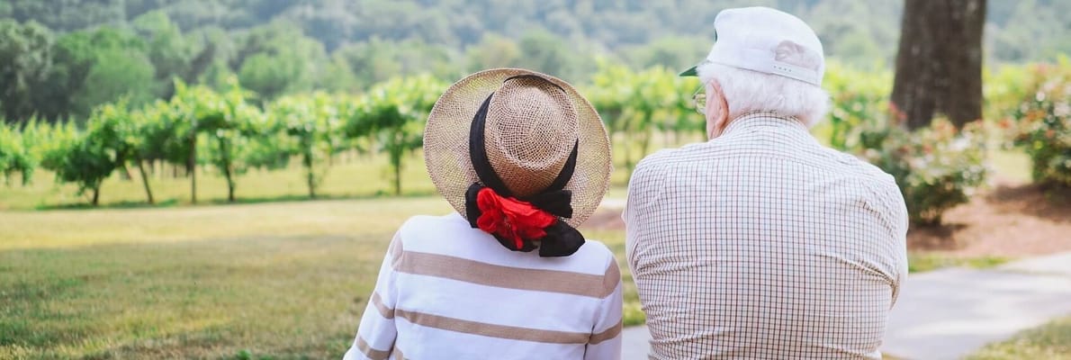Two seniors enjoying a peaceful moment outdoors in a garden