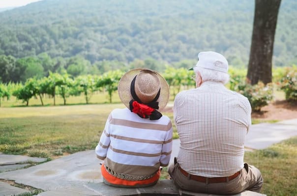 Two seniors enjoying a view in a garden