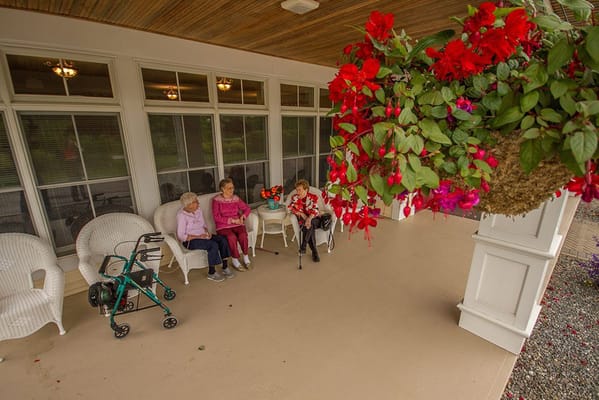 Residents enjoying tea on a covered porch