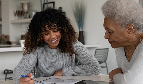 Caregiver assisting a resident with a document