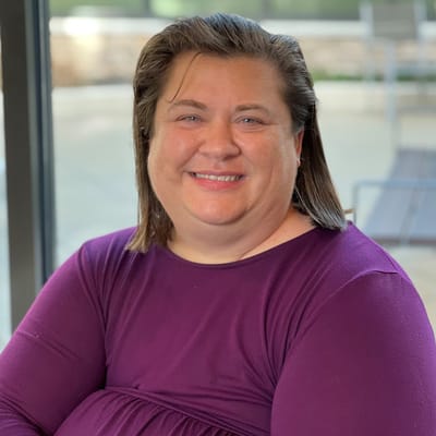 Staff member smiling in a common area