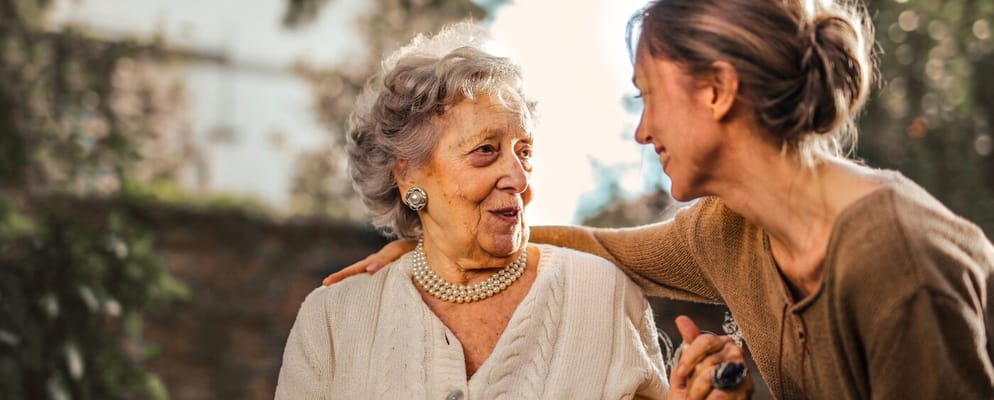 A caregiver and a resident share a joyful moment