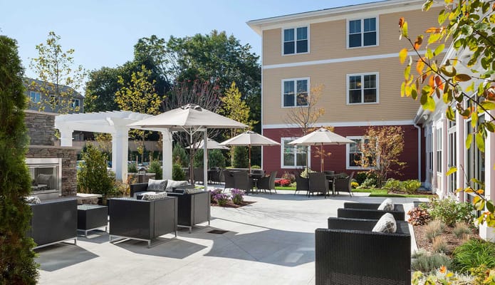 Outdoor seating area with umbrellas and landscaped gardens