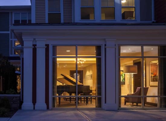 Exterior view of a facility showing a common area with a piano