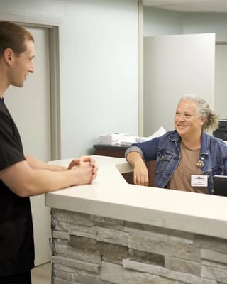 Staff member interacting with a resident at the reception