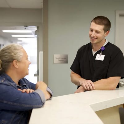 Staff member engaging with a resident at reception