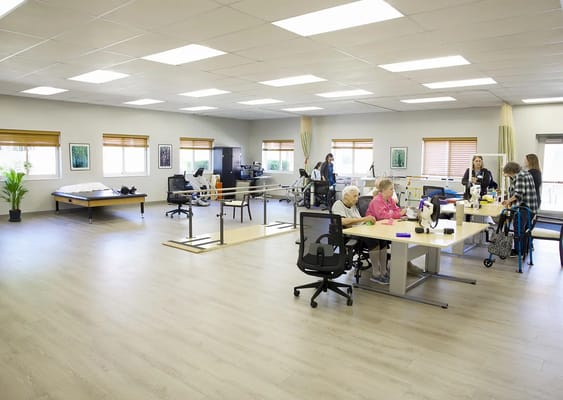 Residents and staff engaging in a therapy room.