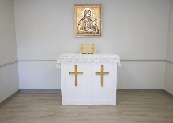 A small chapel area with an altar and religious icon.