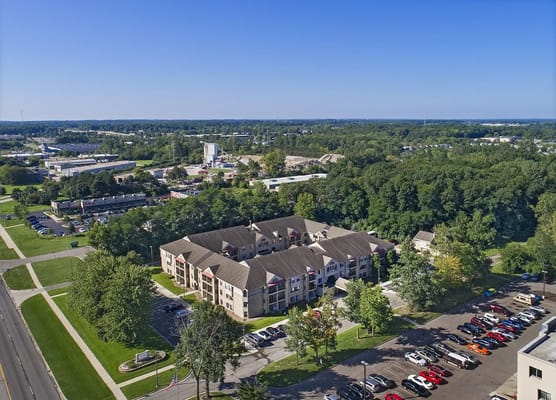 Aerial view of a senior living facility surrounded by greenery
