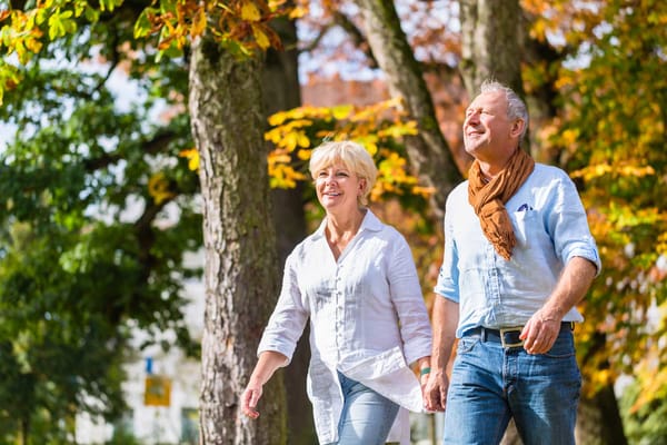 Couple enjoying a walk under autumn trees