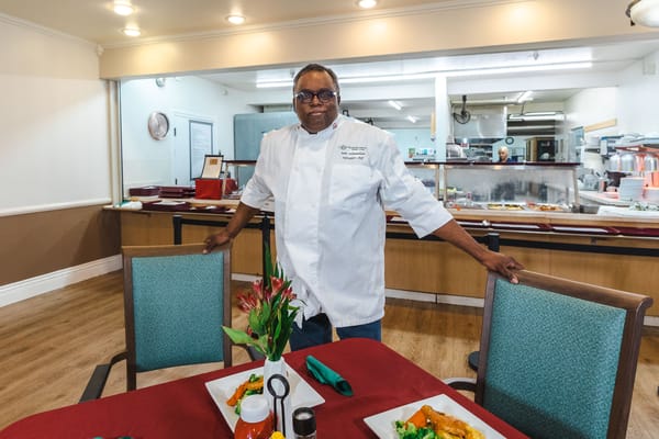 Chef presenting a gourmet meal in the dining area