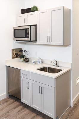 Modern kitchenette with cabinets and appliances