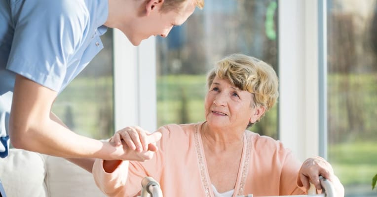 Caregiver interacting with a senior resident indoors