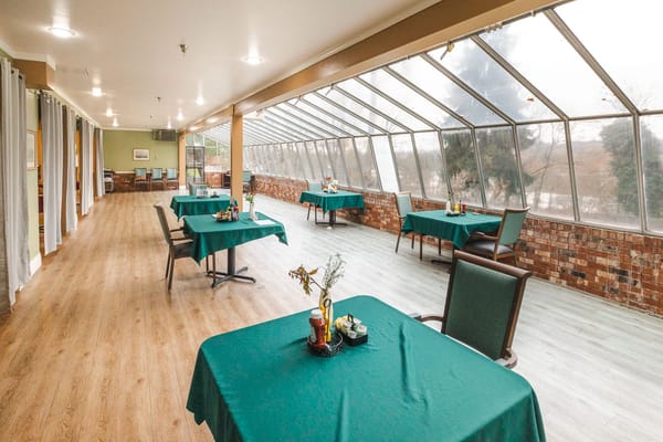 Sunlit common area with tables and chairs