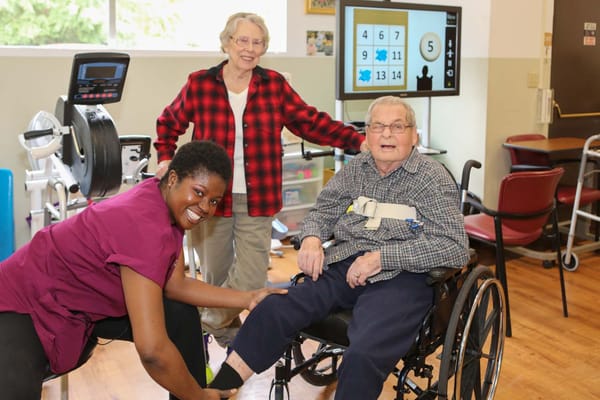 Residents engaging with staff during therapy session