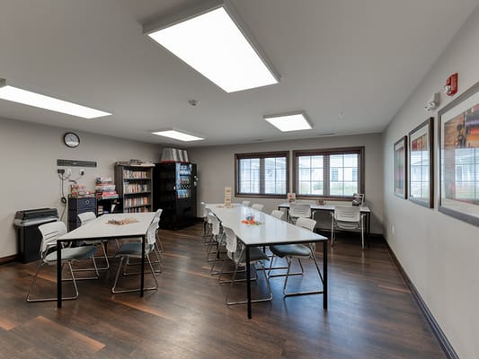 Bright activity room with tables and chairs