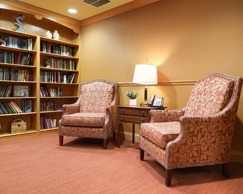 Interior lounge area with comfortable seating and bookshelves