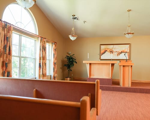 Interior view of a small chapel with pews