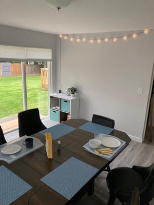 Dining room setup with plates and view of the garden