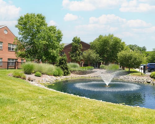 Outdoor view of the facility with a pond and fountain