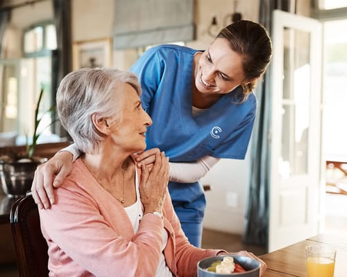 Caregiver interacting positively with a resident indoors