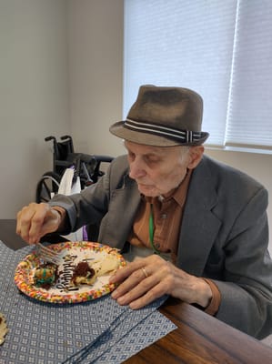 Resident enjoying cake at a birthday celebration