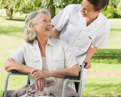 A caregiver assisting a resident outdoors