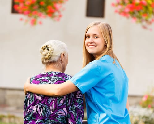 Staff member embracing a resident outdoors