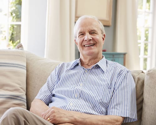 Smiling senior man sitting on a couch