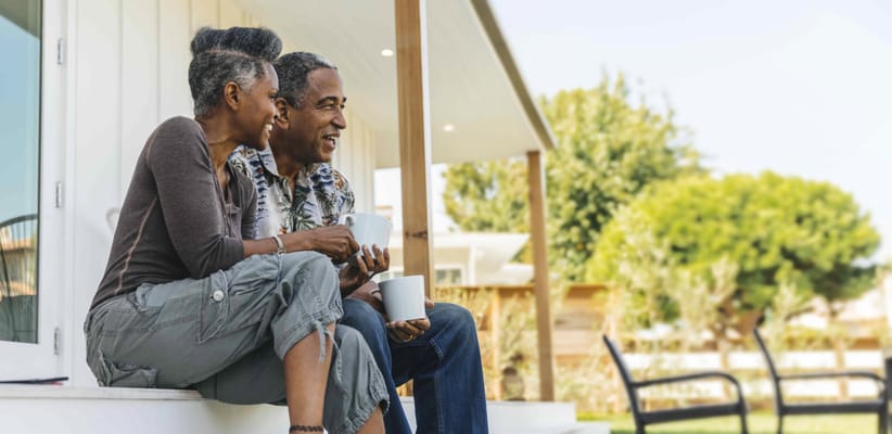 Couple enjoying coffee on a porch