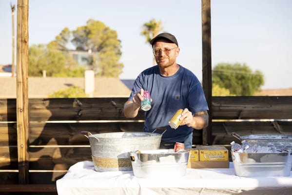 Staff member serving drinks at an outdoor event