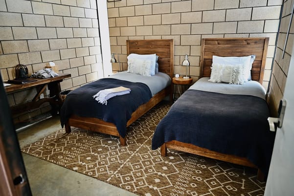 Cozy twin bedroom setup with wooden furniture