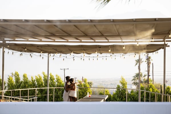 Two women celebrating on an outdoor terrace