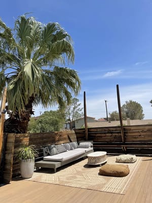 Outdoor seating area with palm tree and decor