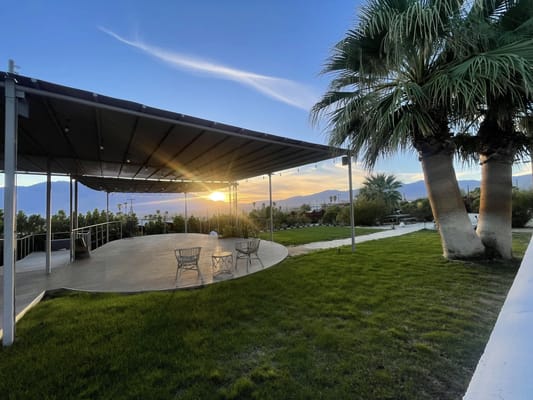 Outdoor area with seating and sunset view