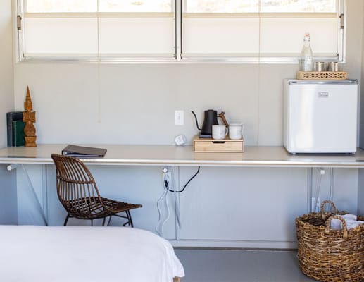 A cozy resident room with a small table and chair