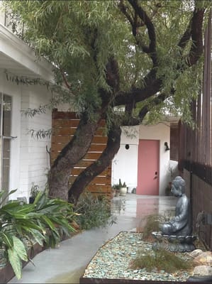 Garden path with a statue and lush greenery
