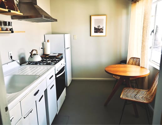 Bright kitchen area with a table and chairs