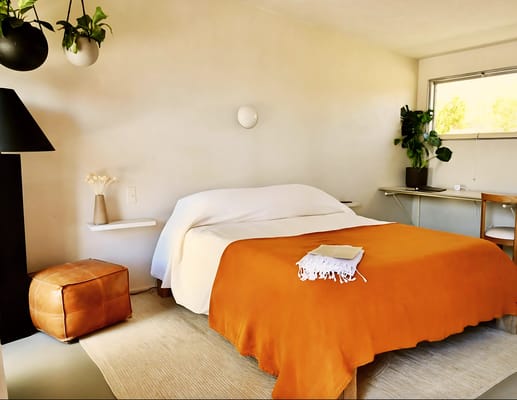 Cozy interior of a living room with an orange bedspread