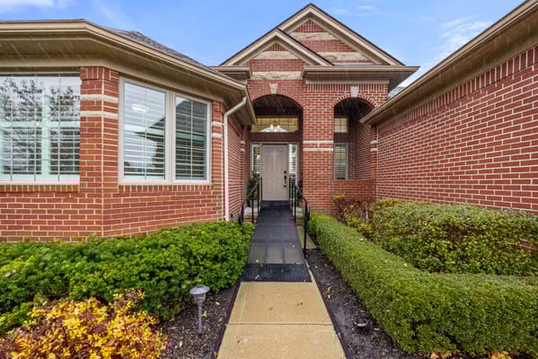 Entrance of a senior living facility with landscaped pathway