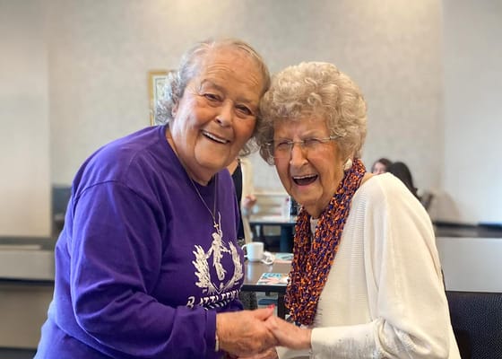 Residents and staff sharing a joyful moment in a common space