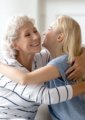 Residents embracing in a warm indoor setting