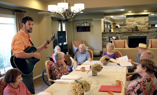 Residents enjoying a music activity in a common area