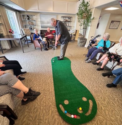 Residents enjoying an indoor putting activity