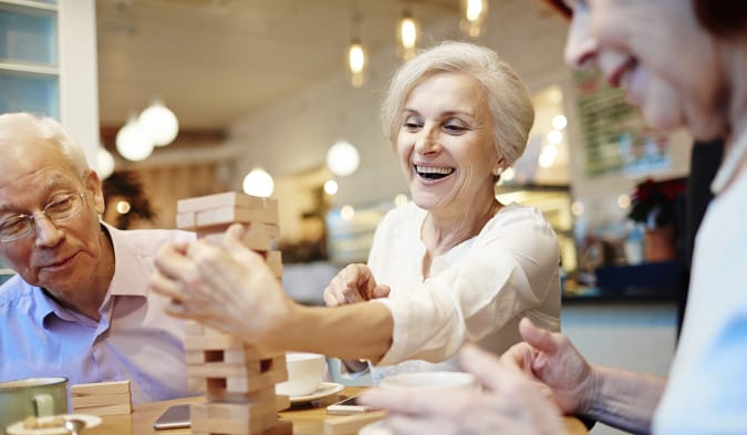 Seniors enjoying a game of Jenga in a common area